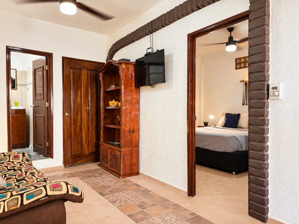 Cozy living area with TV, ceiling fans, and easy bedroom access