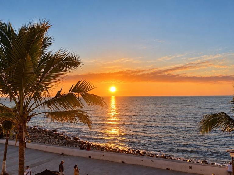 Palm-framed sunset over the bay from Puerto Vallarta's waterfront
