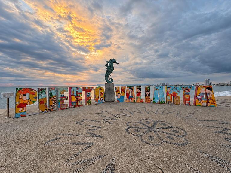 Puerto Vallarta Malecon sign with ocean and skyline views