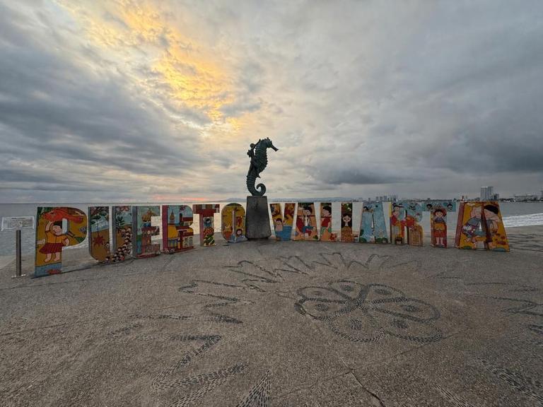 Puerto Vallarta Malecon sign with ocean and skyline views