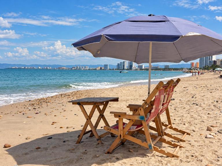 Beach chairs and an umbrella on the sand in Puerto Vallarta