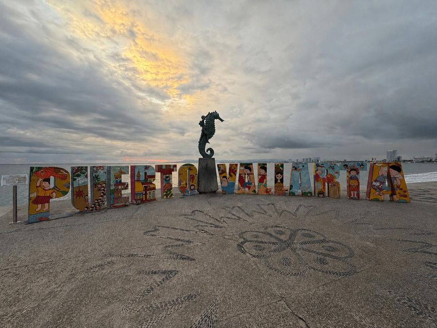 Puerto Vallarta Malecon sign with ocean and skyline views