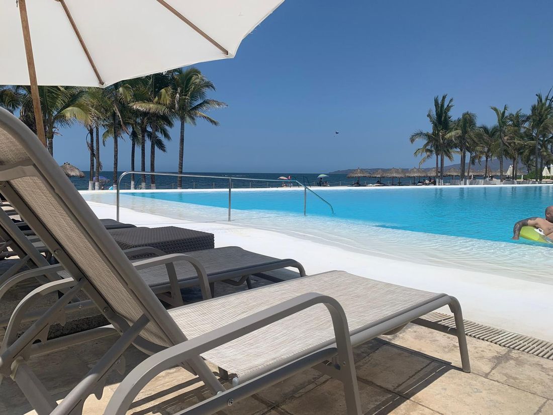 Poolside lounge chairs overlooking the Puerto Vallarta coast