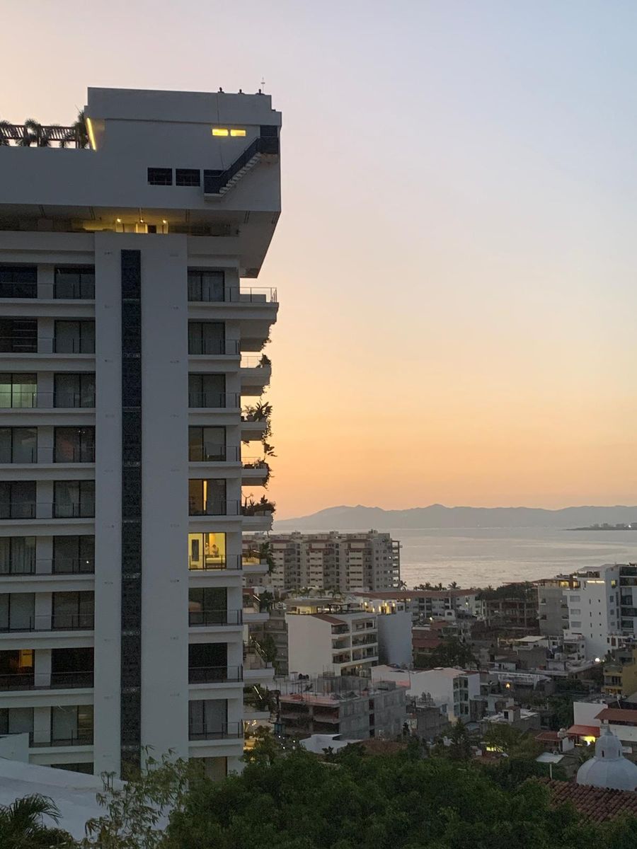 Puerto Vallarta condominium tower overlooking the coastline at sunset
